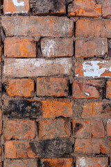 Repair of an old brick wall of a home stove. Different red bricks are laid in the wall after repair. Brick background
