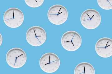 Bright background pattern with a white round clock with a blue second hand on a blue background for your design, top view.