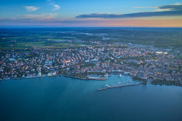 Naklejka premium Aerial view of Desenzano del Garda. Aerial panorama of the town of Desenzano del Garda on Lake Garda in Italy. Top view of the boat parking on the lake. Italian resorts on Lake Garda.