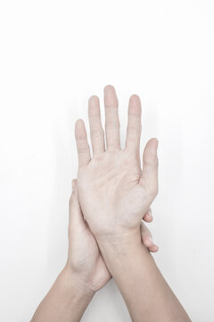 Pale palmar surface of both hands. Anaemic hands of Asian, Chinese man.