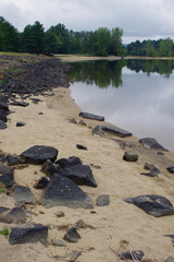 rocks on sandy beach in summer with copy space 