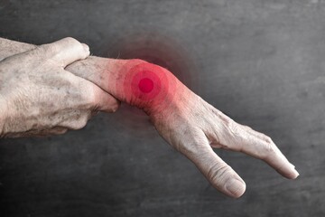 Pain in wrist joint of Asian elder man. Concept of hand pain, rheumatoid arthritis and arm problems.
