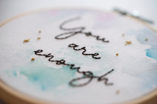 Close-up of an Embroidery hoop with the words you are enough