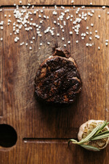 Salty steak of meat on the desk. Portion of meal