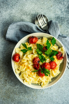 Bowl of farfalle pasta with roasted cherry tomatoes and coriander