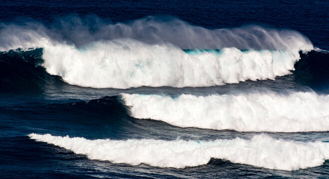 Three Large Waves breaking in ocean, Maui, Hawaii, USA