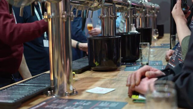 Bartenders pours beer for free tasting. The tasting is open for free admission, without presenting a QR code