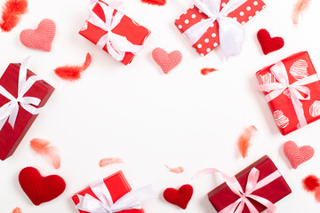 A holiday card with knitted hearts and feathers. A frame for a banner for Valentine's Day. Background on February 14. Copy space. Flat lay, top view