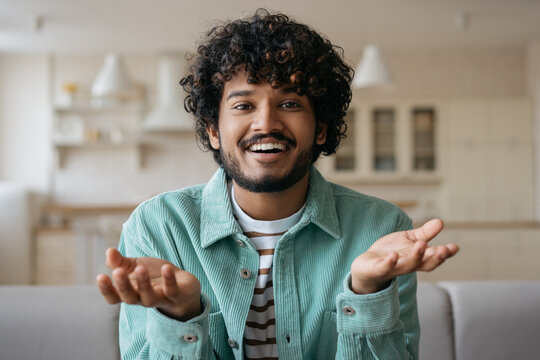 Young handsome Indian freelancer communication online working from home, video conference concept. Smiling man having video call. Successful asian influencer recording video talking to camera - Powered by Adobe
