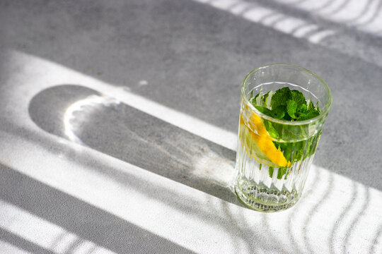 Glass Of Lemon Water With Mint On A Table