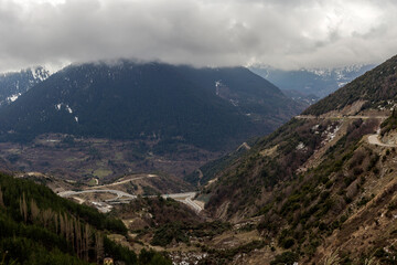 Fototapeta premium Winter in the mountains (Epirus region, Greece) and country road on a winter day