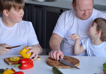 father and sons preparing food