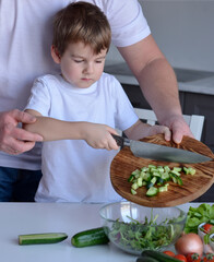 father and son preparing salad