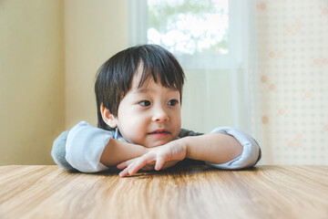 Fototapeta premium Happy asian little boy on bed.