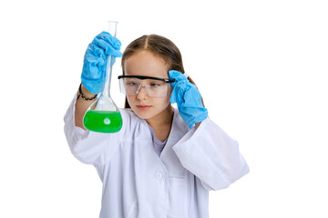 Naklejka premium Portrait of little school girl, kid in white big gown as chemist, scientist doing experiment with multicolored chemical fluid in laboratory isolated on white background
