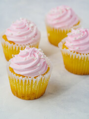 Sweet cupcakes with pink cream on a white background. Close-up. Birthday, card, holiday invitation, advertising, banner, food design. Close-up.