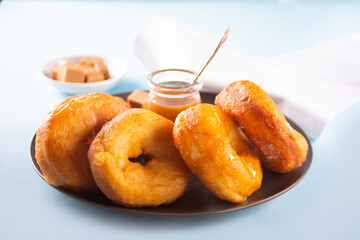 Homemade delicious donuts with caramel syrup sauce on the plate
