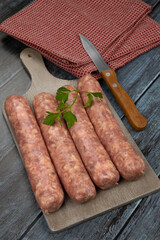 Toulouse sausages on a gray wooden board