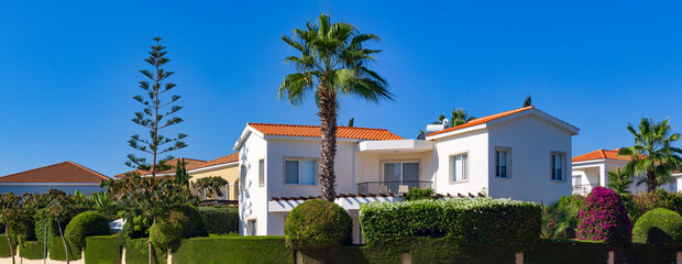 The picturesque Mediterranean landscape of the village of Pissouri: white houses with orange roofs are scattered across the countryside of Cyprus