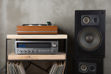 HiFi system with turntable, amplifier, headphones and lp vinyl records in a listening room - obrazy, fototapety, plakaty
