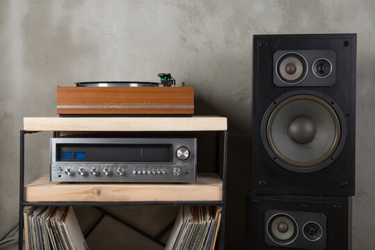 HiFi system with turntable, amplifier, headphones and lp vinyl records in a listening room