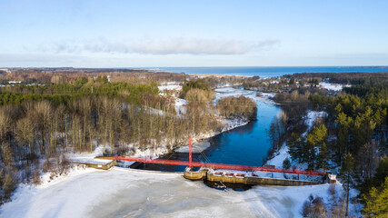 Aerial view to the Linnamäe hydro power station with dam and water reservoir on natural salmon river in Jägala river, Harju county, Estonia