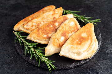 homemade fried chebureks on a stone background