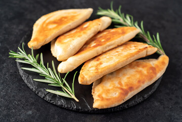 homemade fried chebureks on a stone background