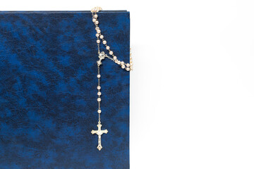 Fototapeta na wymiar Rosary on the Bible, dark color, cross, religion, prayer. isolated