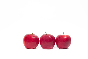 Three ripe red apples on a white background isolated