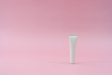 White plastic tube on pink background. Сosmetic bottles for beauty or medicine products