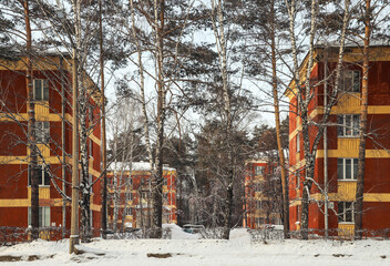 Fototapeta na wymiar Old small residential area in the middle of the forest in winter. Outdoors
