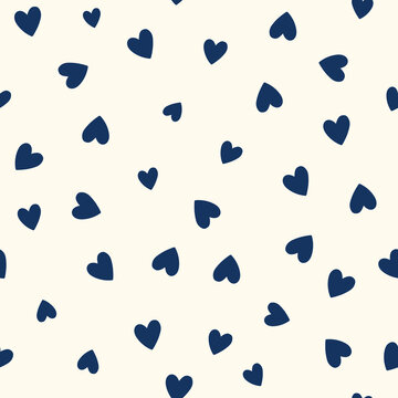 All over seamless vector repeat pattern with ditsy small navy blue hand drawn doodle hearts tossed on cream background. Simple cute Valentines day background