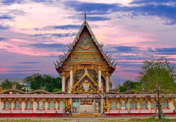 beautiful Way Buddhist temples in Phuket Thailand. Decorated in beautiful ornate colours of red and Gold and Blue. Lovely sunset