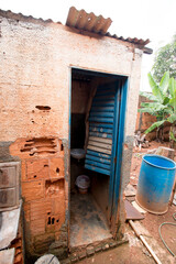 An Crudely Built  Bathroom that is detached from the rest of the house which is common in Brazil.