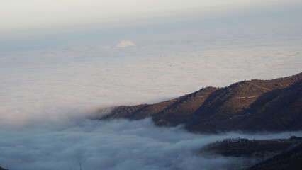 Foothills covered with white clouds