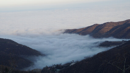 Foothills covered with white clouds