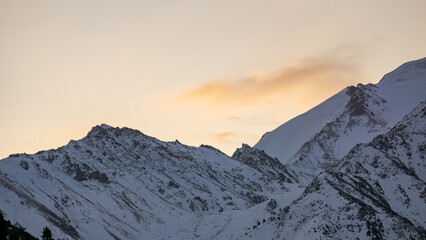 Cloudy dawn over a mountain peak