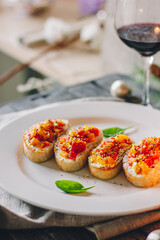 Catering table set service at restaurant before party. Canapes bruschetta with seeds, mozarella and tomatos.