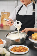 confectioner wearing black uniform while working in confectionery.