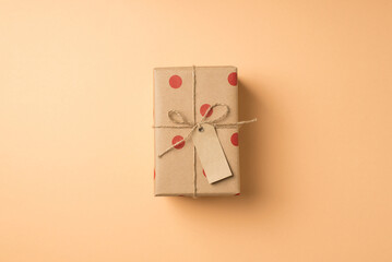 Top view photo of saint valentine's day decorations craft paper giftbox with polka dot pattern tag...