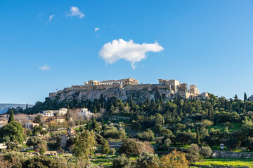 Fototapeta na wymiar Panorama of the Acropolis. Ancient Greek Parthenon on Acropolis hill is a top landmark of Athens. Scenery of the famous monuments in the Athens center in summer. Landscape with ruins