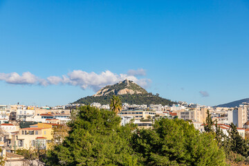 Obraz premium Cityscape of Athens and Lycabettus Hill also known as Lykabettos Lycabettos or Lykavittos. It is a Cretaceous limestone hill in Athens Greece
