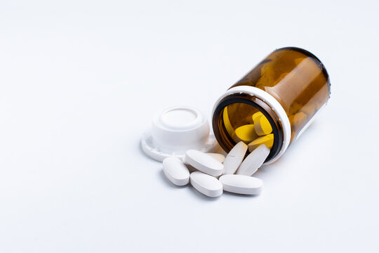Pills and bottle on the white background with copy space
