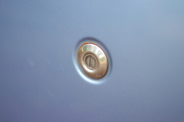 Close-up view of the car door key slot of baby blue modern car