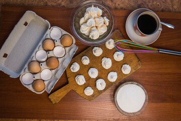 Delicious crispy homemade egg meringue, prepared with love on a wooden background, crunchy dessert for coffee or tea.