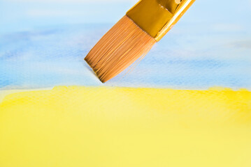 Brush with blue and yellow paint watercolor. Ukraine, Ukrainian flag concept