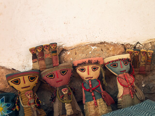 Ancient Prehispanic doll from Cusco, Peru made of old fabric on white background - obrazy, fototapety, plakaty