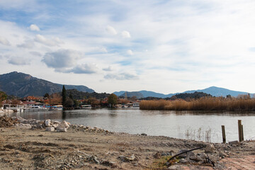 A beautiful lake view but construction near the lake. There are rocks, rebars and lake on the same photo. Wide angle. 