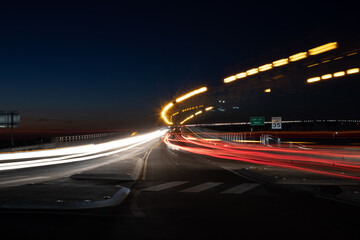 Light trails of cars on a bridge at night